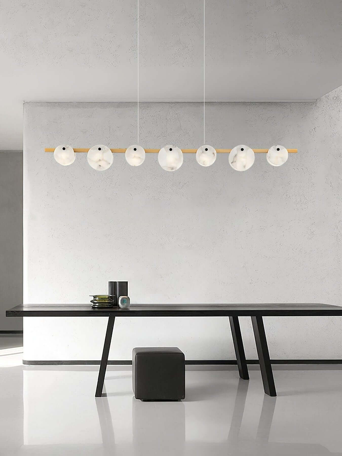 Frumix alabaster chandelier with 7 spherical lights over a modern dining table, showcasing mid-century modern lighting.