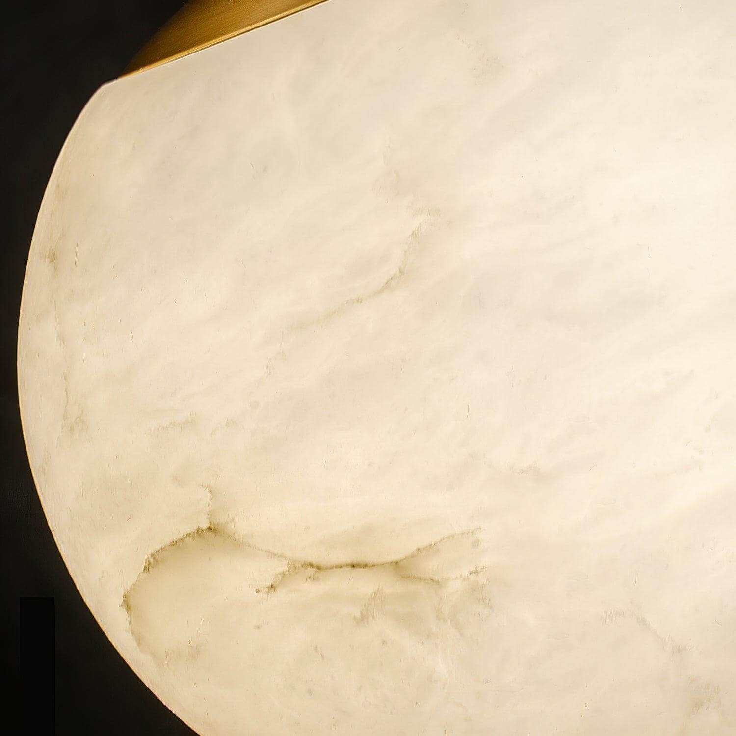 Close-up of natural alabaster stone veining on the illuminated Velriq pendant shade