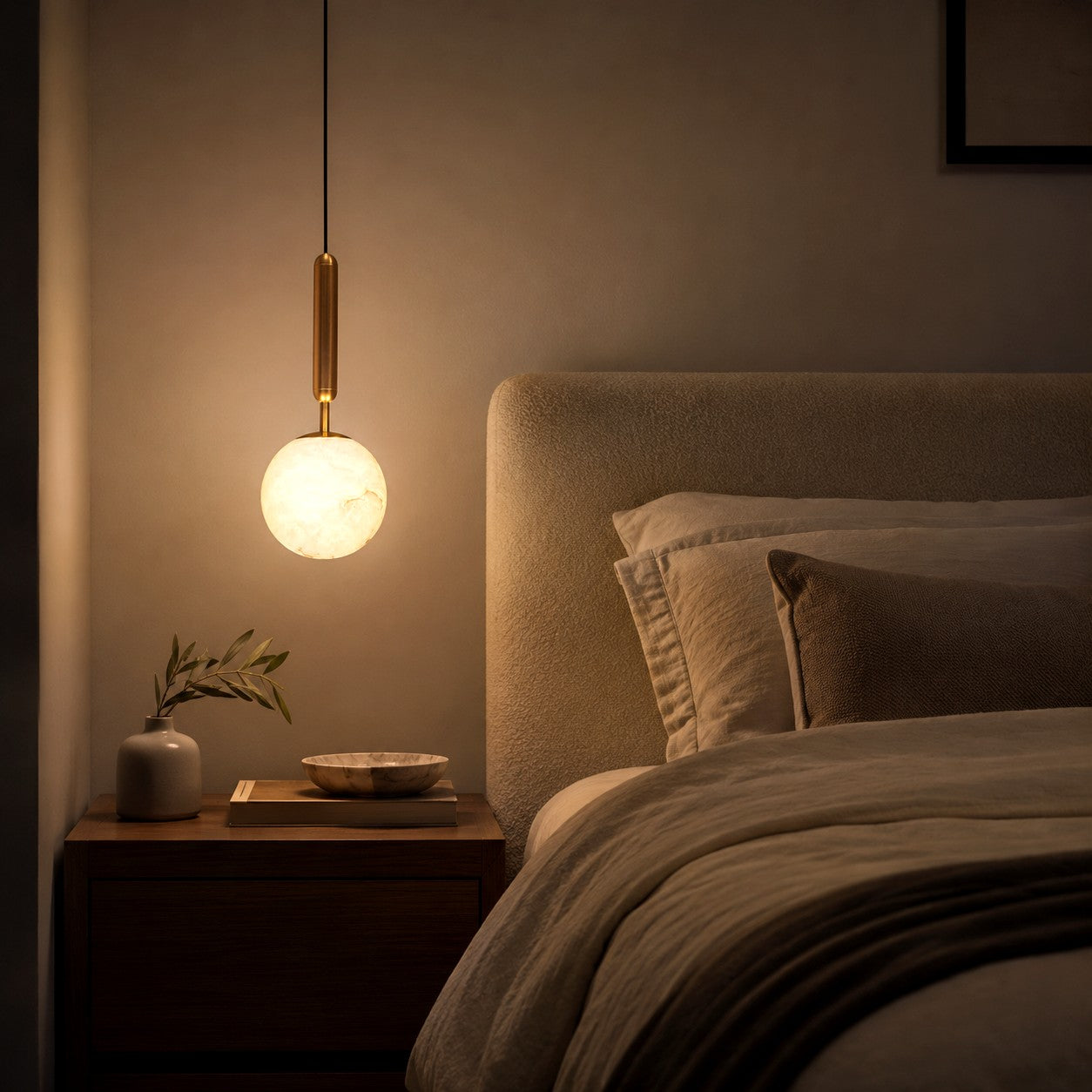 Velriq alabaster bedside pendant light creating a warm ambient glow in a dark bedroom