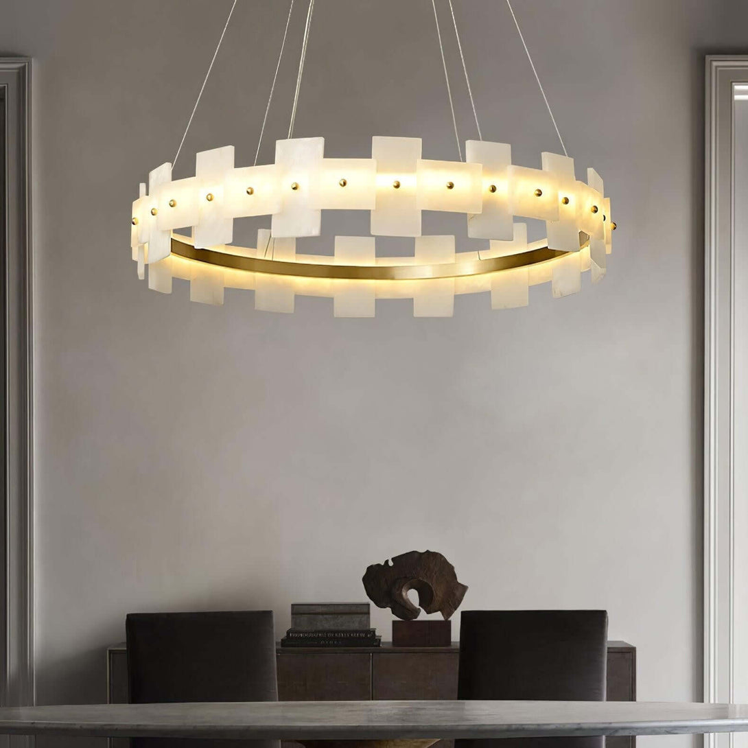 Elegant Omvilo alabaster chandelier above a modern dining room table, featuring vintage brass accents.