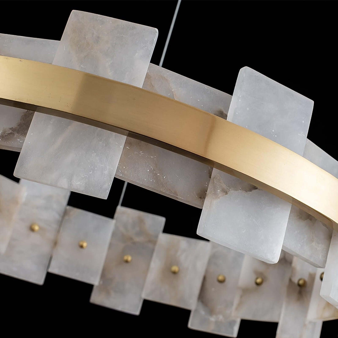 Close-up of Omvilo alabaster chandelier with brass accents for elegant dining room decor.