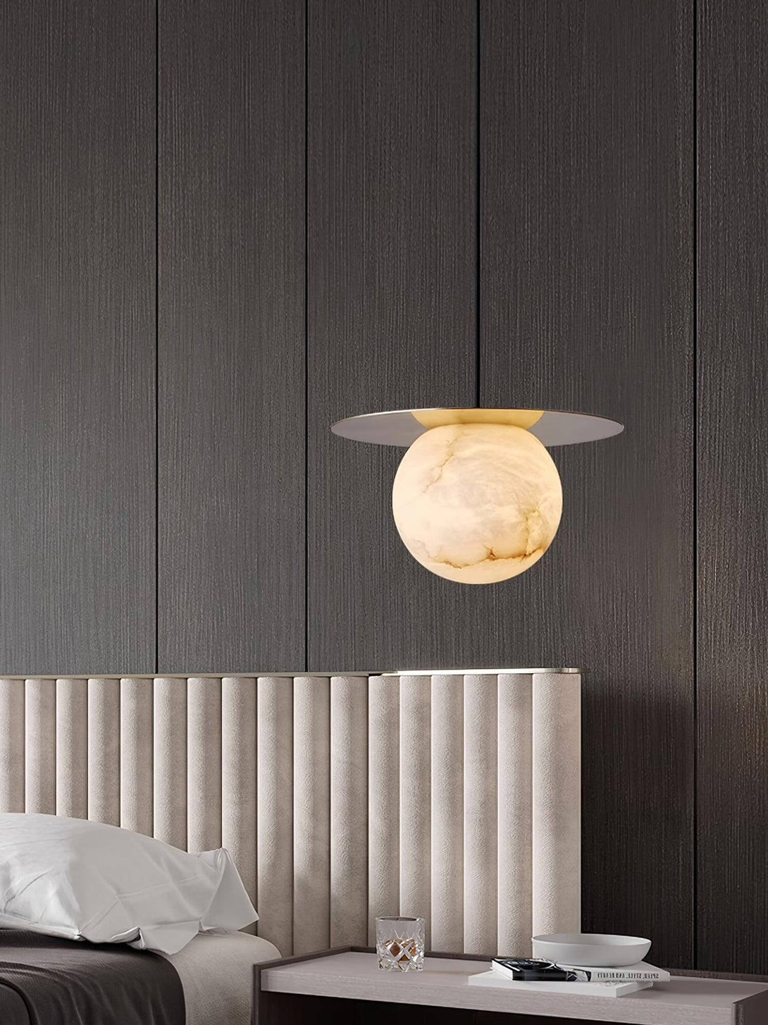 Stylish alabaster pendant light above a modern bed in a sleek bathroom, perfect for scandi decor.