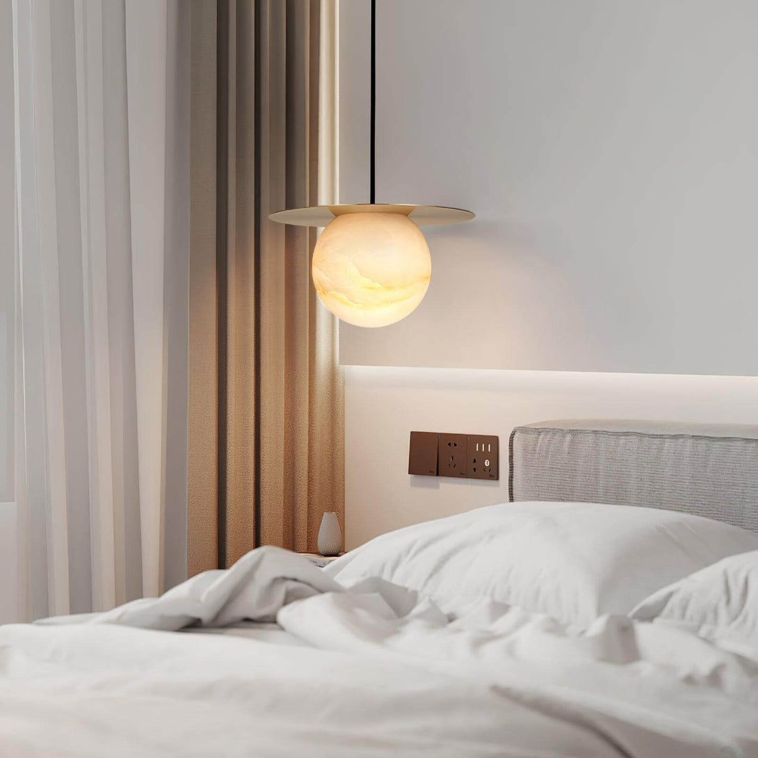 Stylish Orbix pendant light in alabaster over a cozy bed, ideal for Scandi and bathroom lighting.