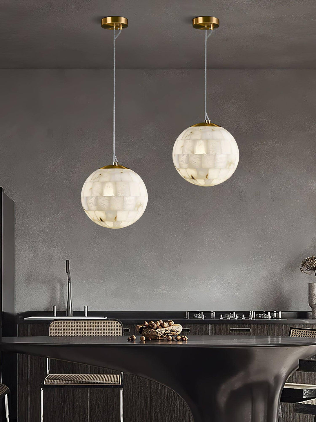 Zarqe alabaster spherical pendant lights illuminating a modern kitchen with stylish fixtures.