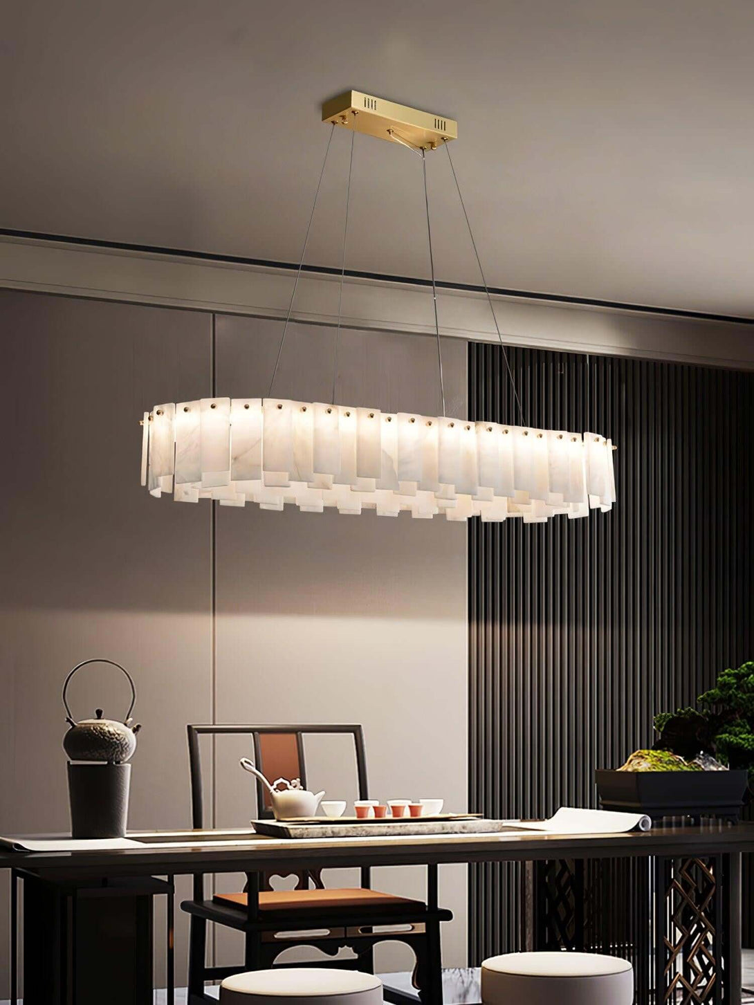 Zemora alabaster chandelier hanging in a modern dining room, exuding mid-century elegance and round lighting design.