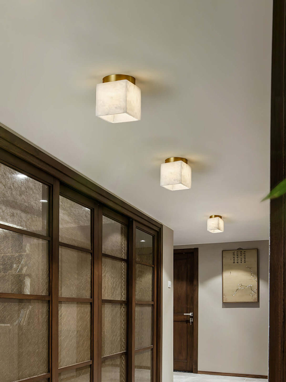Stylish Zolume ceiling light fixtures in a modern hallway, showcasing alabaster and gold finish for art deco decor.