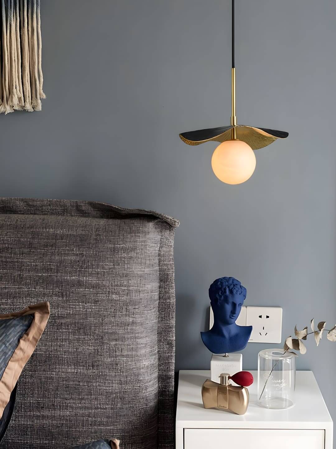 Stylish contemporary pendant light with gold and navy accents, perfect for bedrooms or modern dining areas.