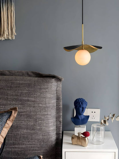Stylish contemporary pendant light with gold and navy accents, perfect for bedrooms or modern dining areas.