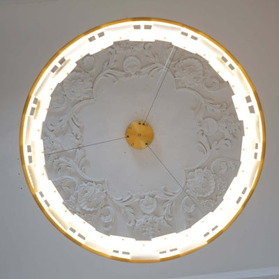 Intricate plaster ceiling design with backlit rim, showcasing a vintage aesthetic.