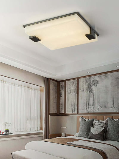 Faylen ceiling light in a cozy bedroom, showcasing alabaster flush mount design and mid-century style.