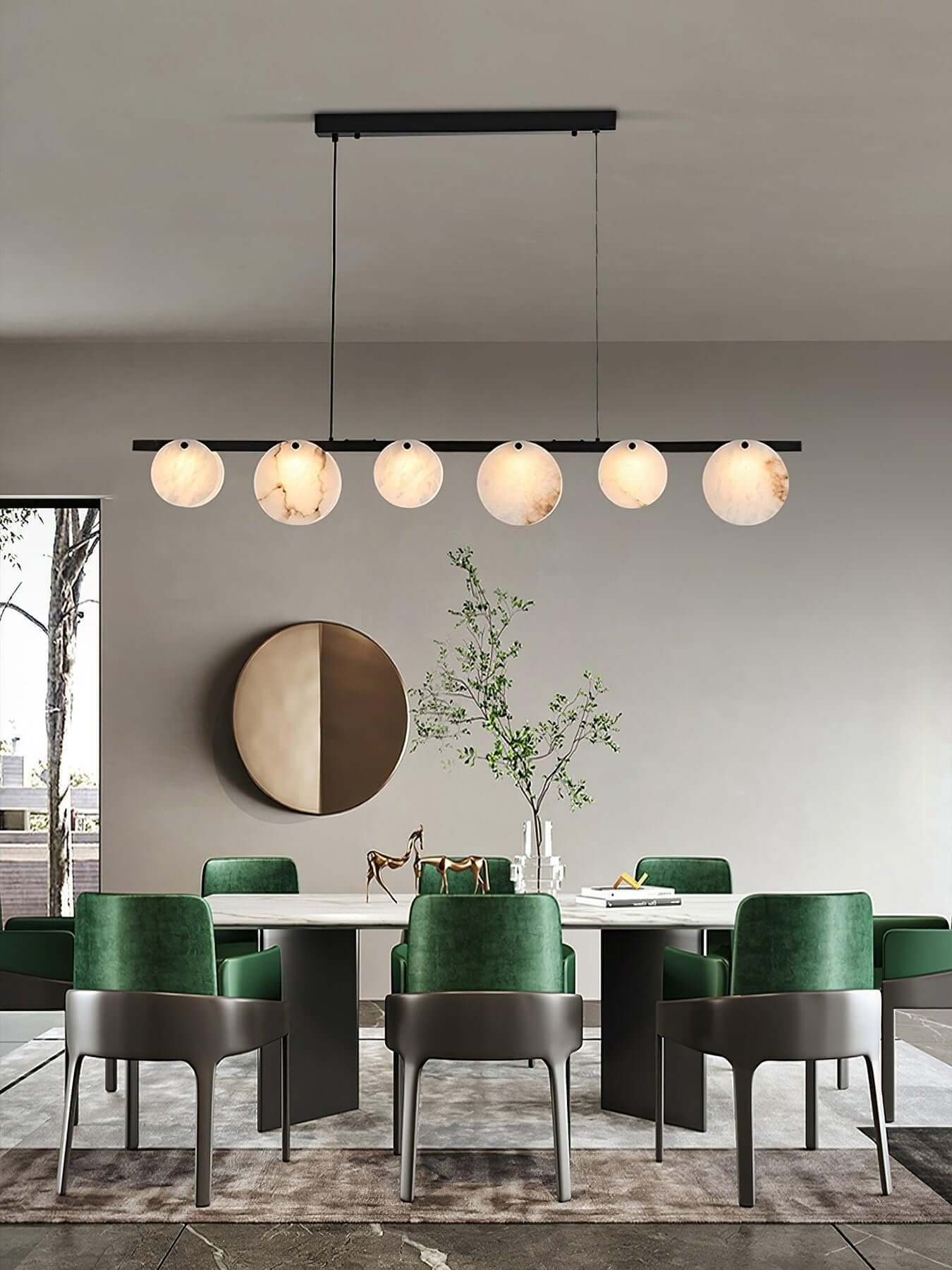 Frumix alabaster chandelier in a mid century modern dining room with green chairs and a round mirror decor.