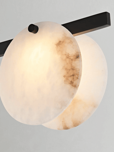 Frumix alabaster chandelier close-up showing mid century modern design and warm lighting effect.
