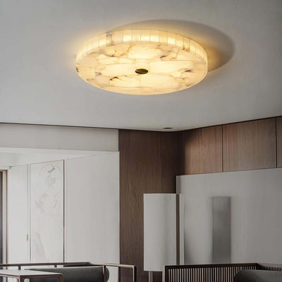 Round LED ceiling light with alabaster finish, perfect for modern bedroom decor, providing soft ambient lighting.