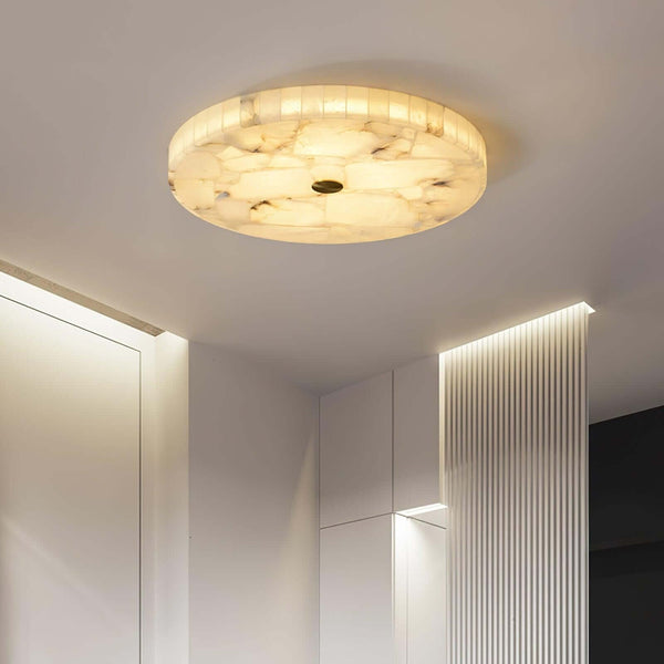 Round alabaster flush mount light, elegant LED ceiling lamp illuminating modern interior.