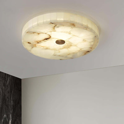 Round alabaster flush mount ceiling light, ideal for modern bedroom decor, providing stylish illumination.