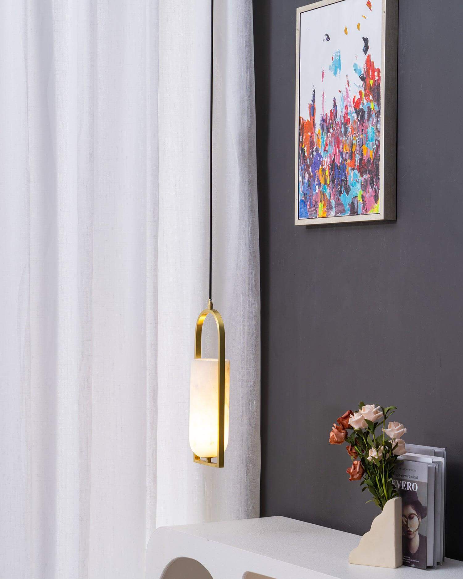 Orleni pendant light illuminating a modern interior, showcasing alabaster and mid-century design elements.