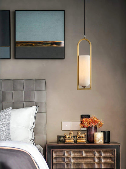 Orleni pendant light above a stylish bedside table, showcasing mid-century modern design and alabaster style.