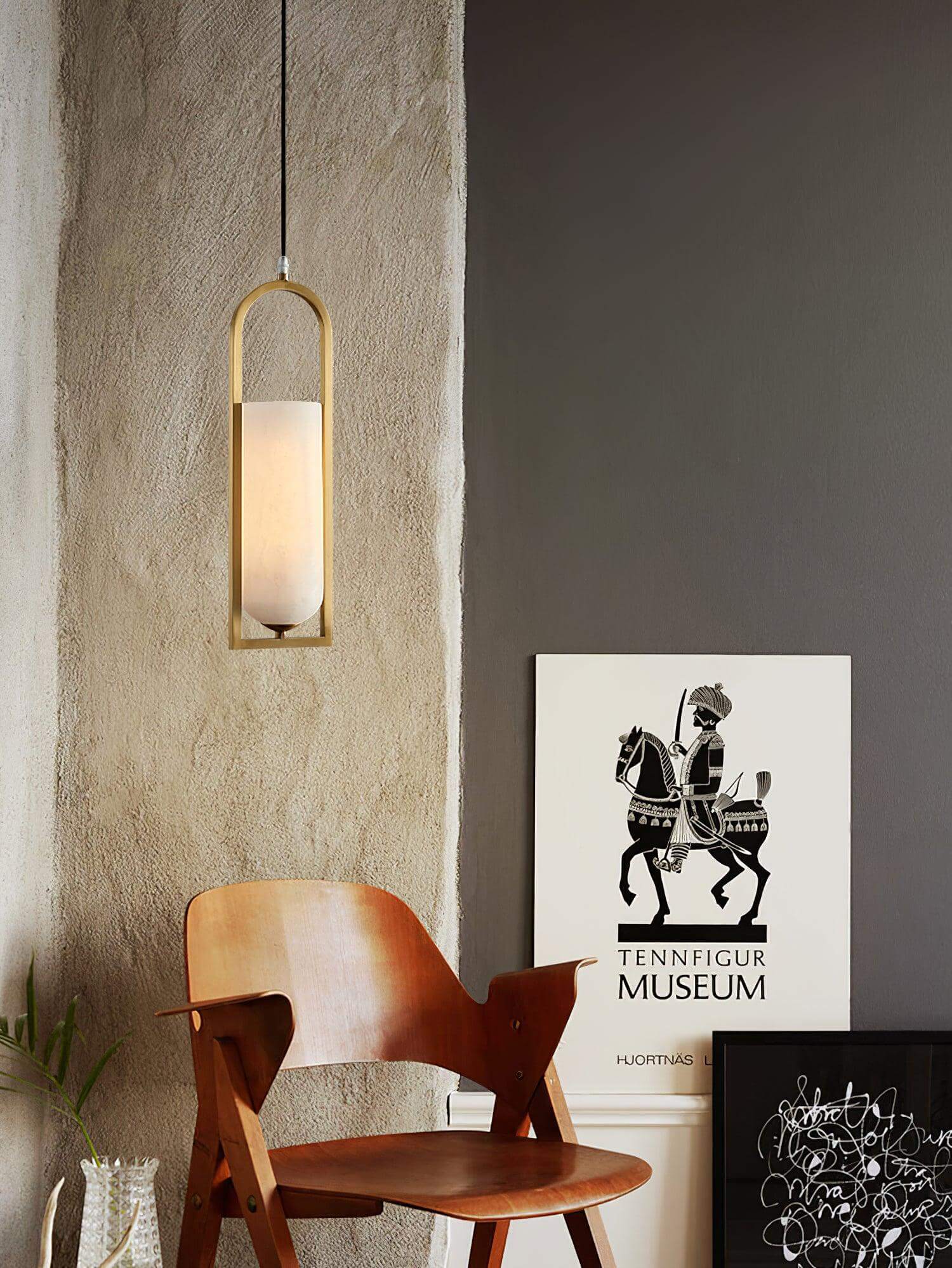 Orleni pendant light in mid-century modern style, hanging beside an art piece, showcasing alabaster shade and elegant design.