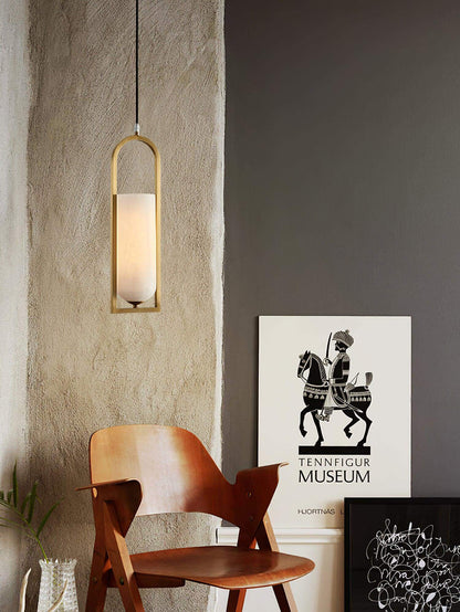 Orleni pendant light in mid-century modern style, hanging beside an art piece, showcasing alabaster shade and elegant design.