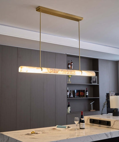Qemir Chandelier over modern kitchen island, alabaster linear light fixture for dining room, stylish home decor.