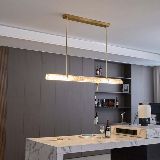 Stylish Qemir chandelier in modern dining room, featuring alabaster and gold finish, perfect light fixture.