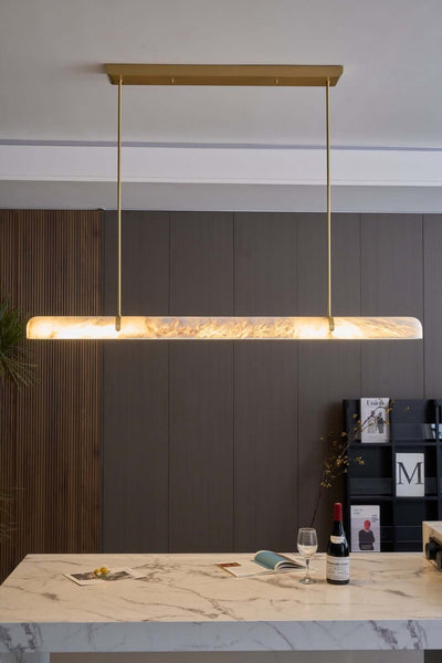 Qemir chandelier over a dining table, modern linear alabaster light fixture for stylish dining rooms.