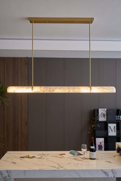 Qemir chandelier over a dining table, modern linear alabaster light fixture for stylish dining rooms.
