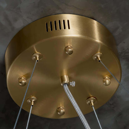 Close-up of a decorative brass ceiling plate for a chandelier, showcasing modern design and elegant finishes.