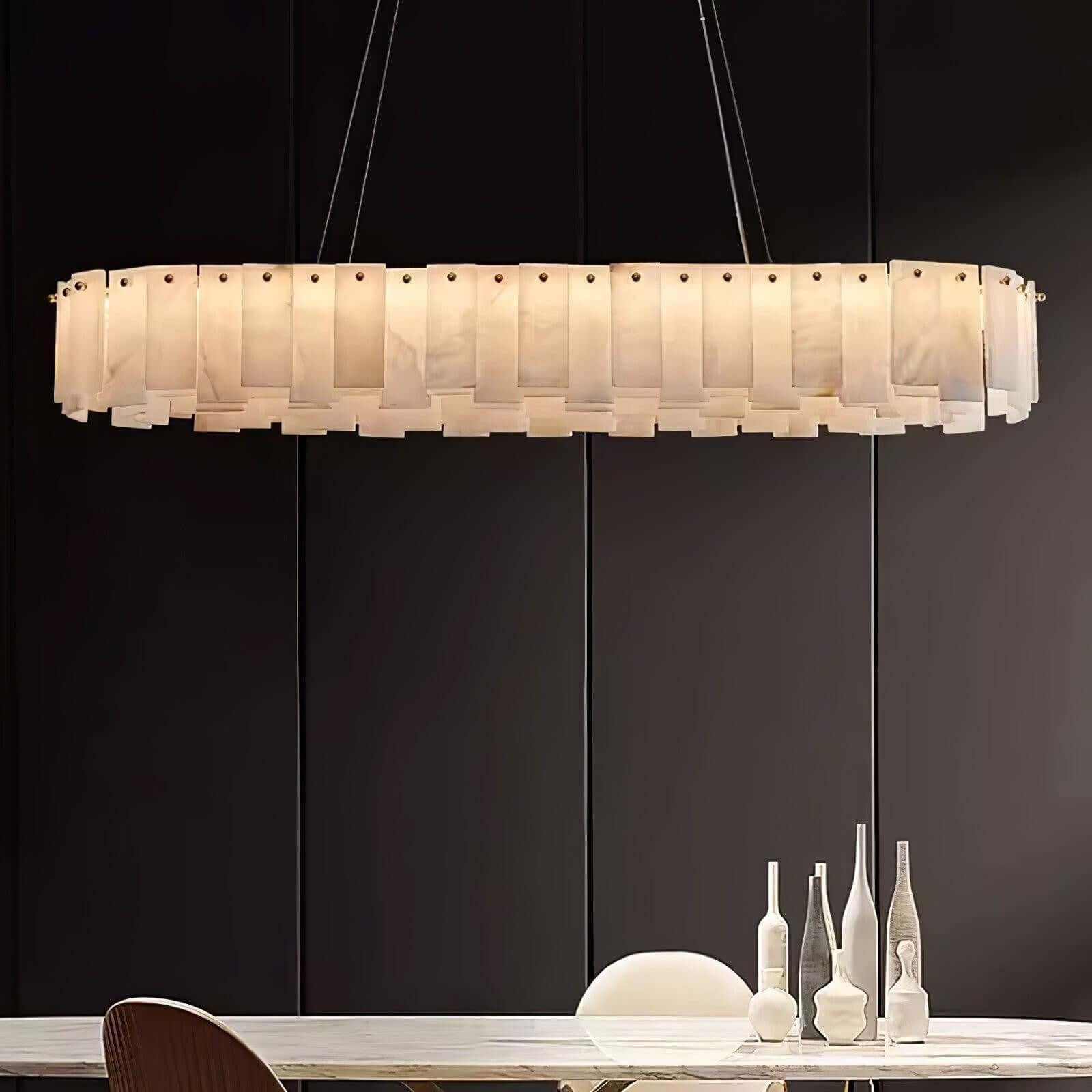 Zemora chandelier, round alabaster design, mid-century modern lighting fixture hanging over a dining table.